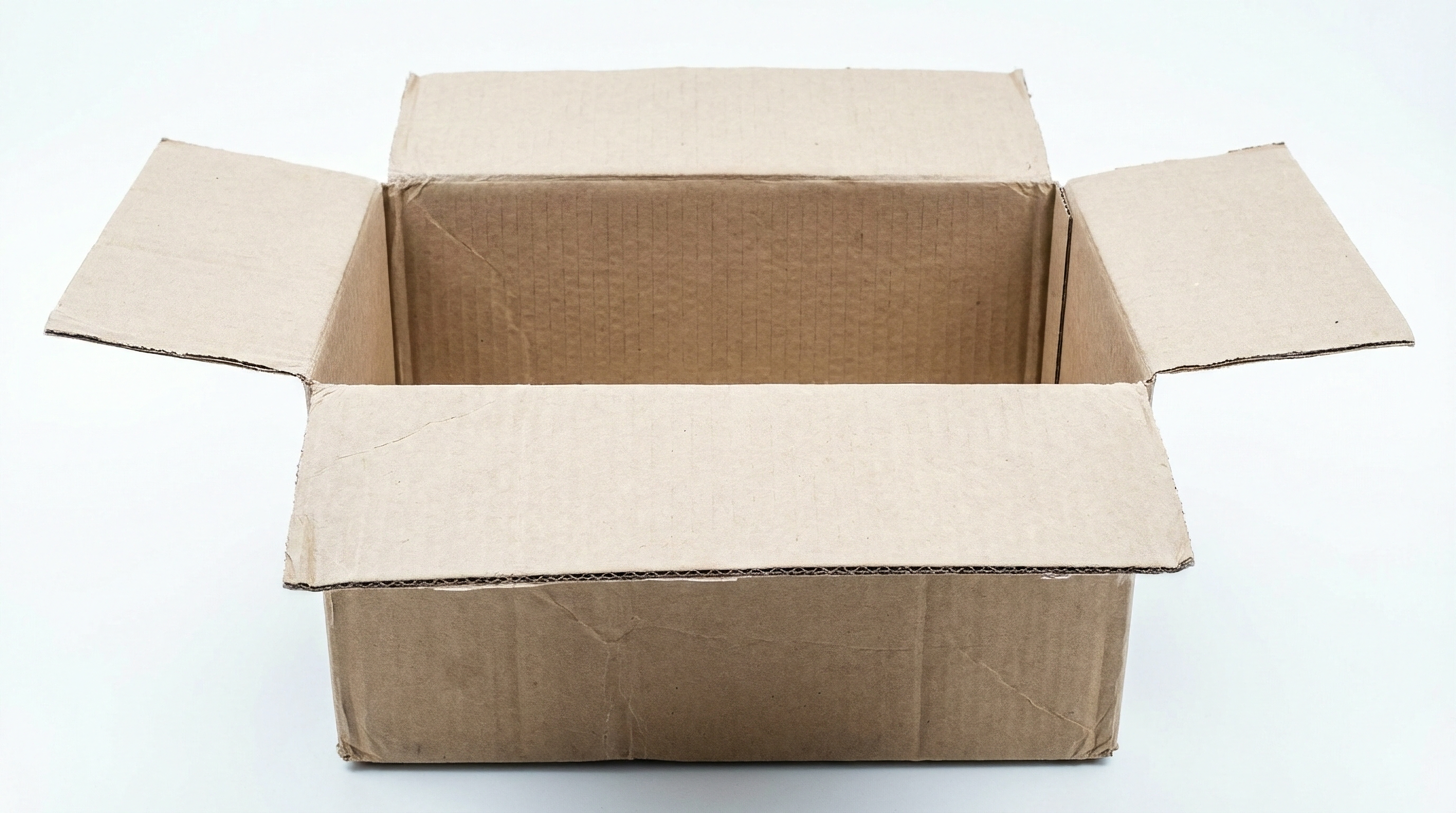 Open used corrugated shipping box on a white background